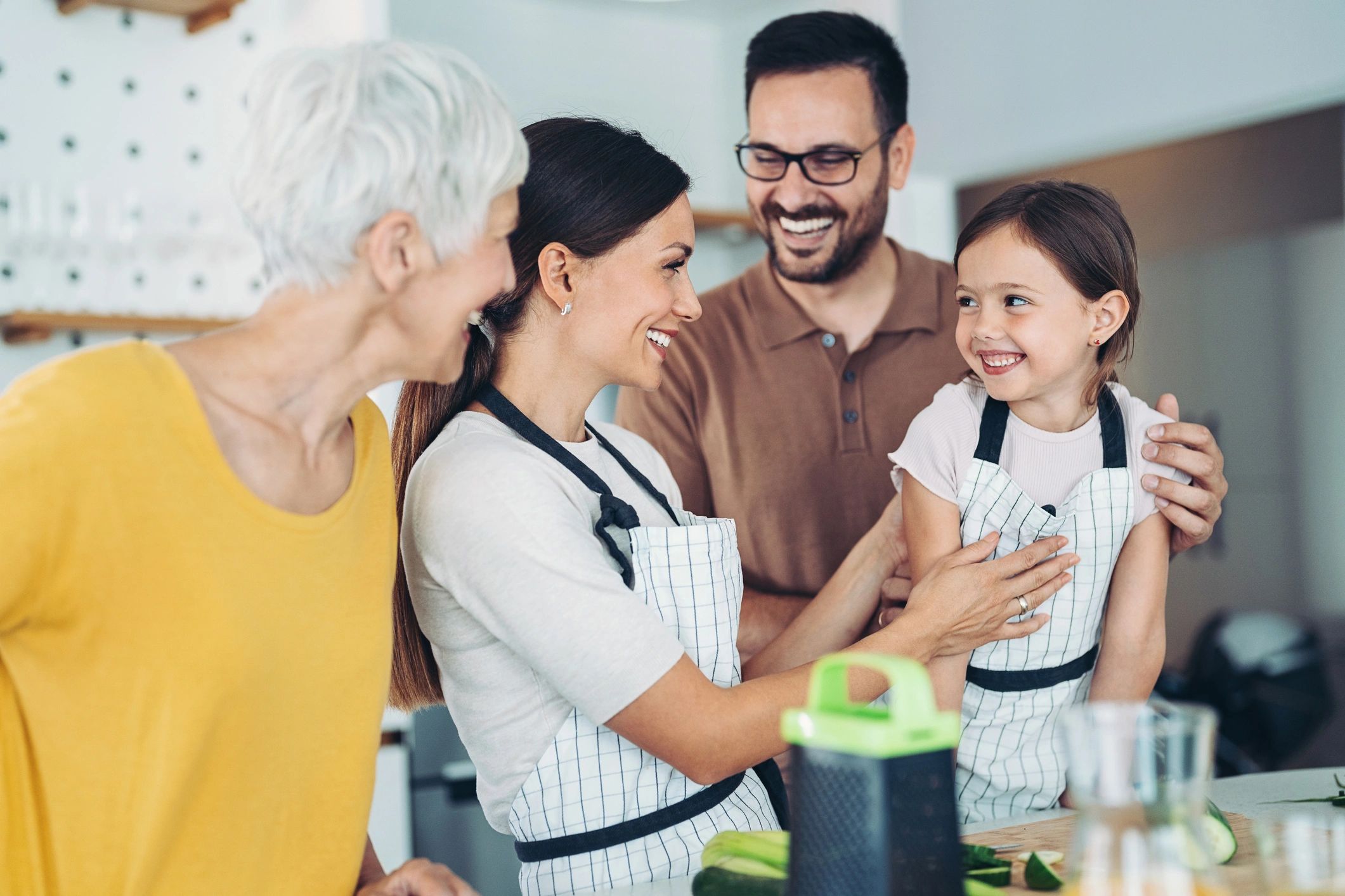 Multi-generation family cooking together in a kitchen