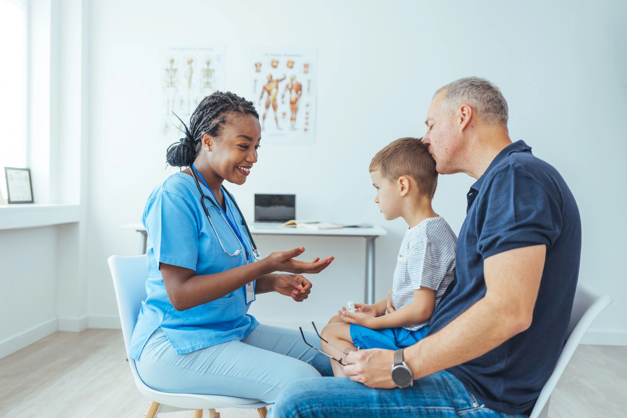 Pediatrician speaking with a parent and child