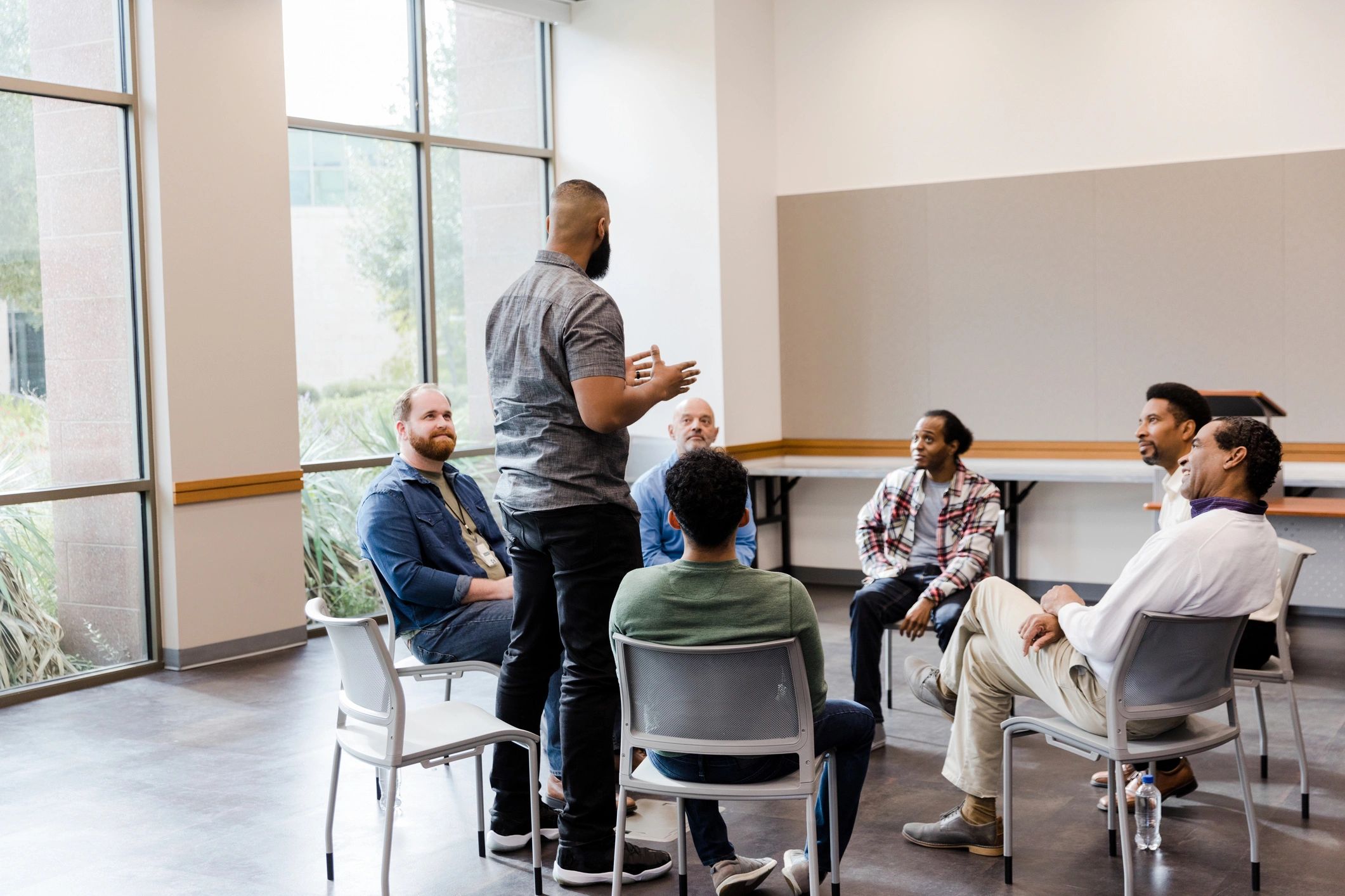 Facilitator speaking to a diverse community group during a health education session
