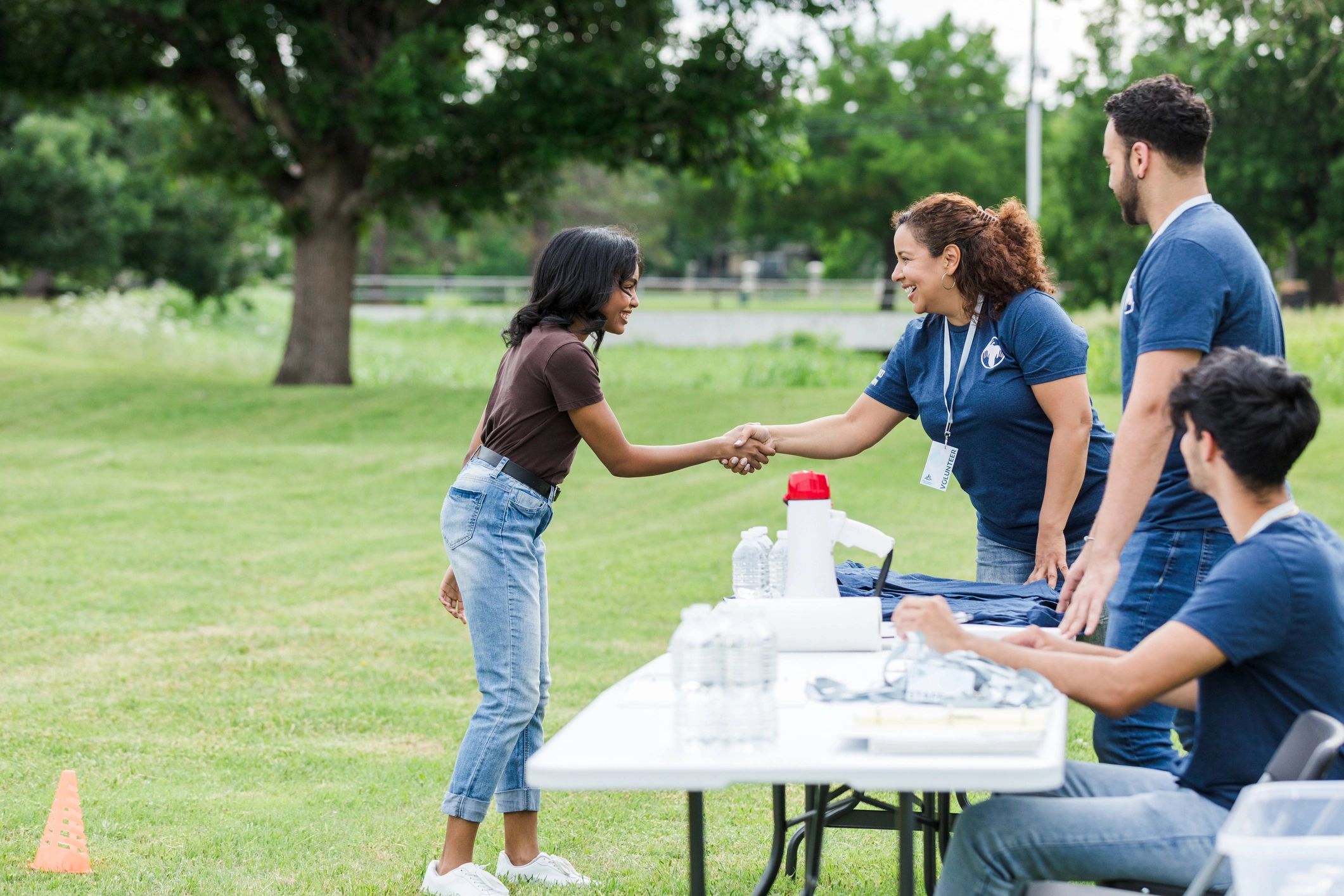 Volunteer coordinator greeting a new volunteer at a community event