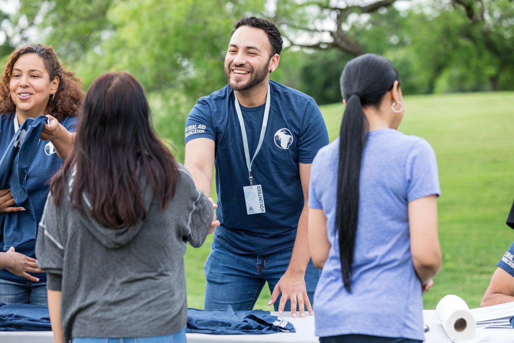 Volunteer greeting a community member with a handshake