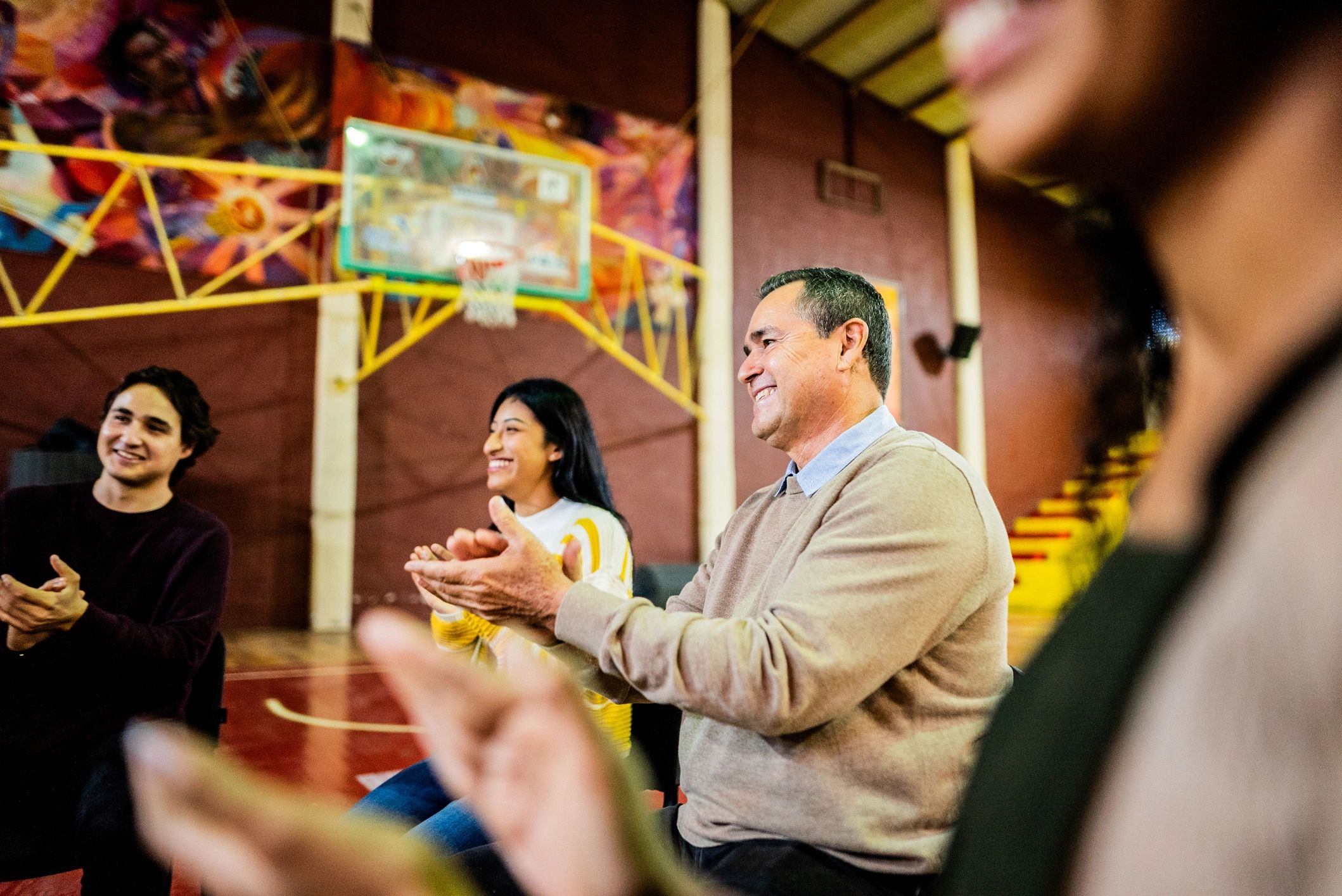 Facilitator applauding during a supportive group session